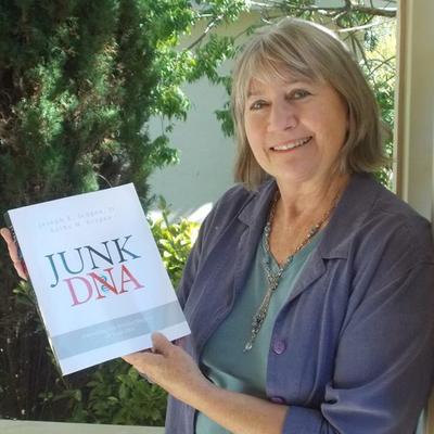 Kathy M. Scogna holding a copy of Junk DNA